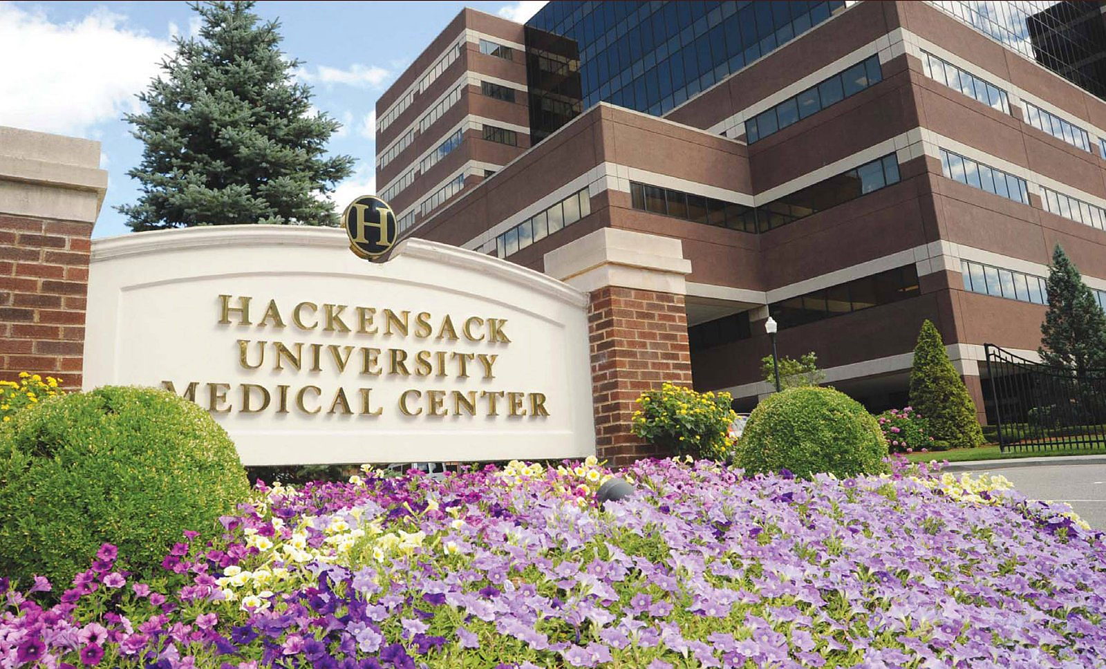 The entrance sign and main building of Hackensack University Medical Center.