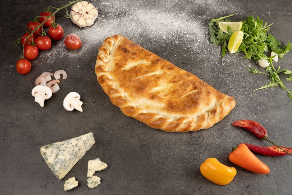 Calzones — Pizza dough folded over cheese and fillings, then baked sealed.