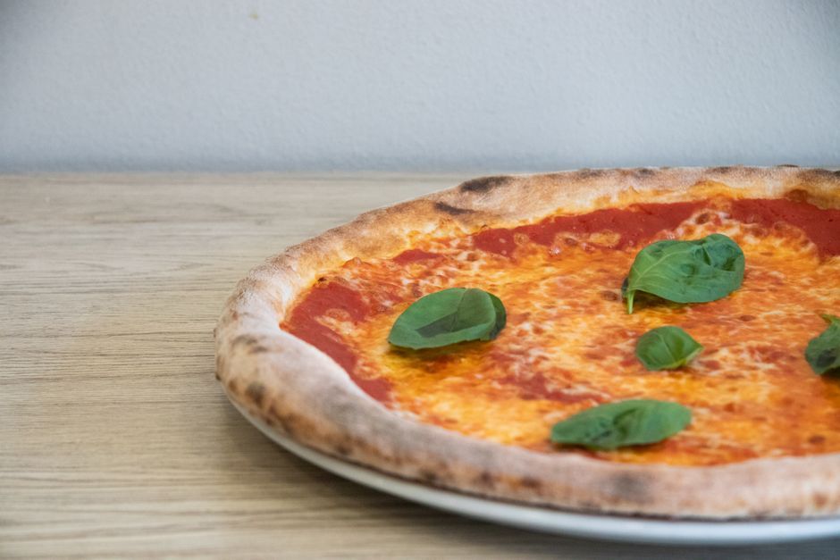 Margherita — Tomato, fresh mozzarella and basil — the classic Neapolitan style.