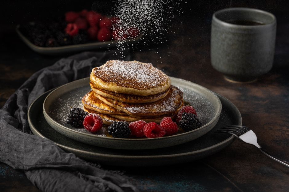 Pancakes — Griddled batter cakes, served stacked with syrup.