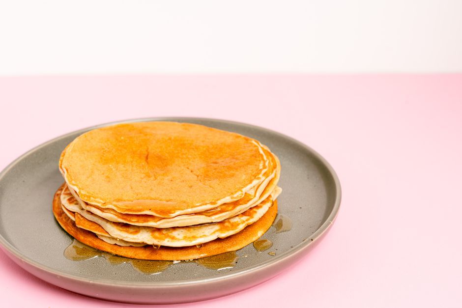 Pancakes — Griddled batter cakes, served stacked with syrup.