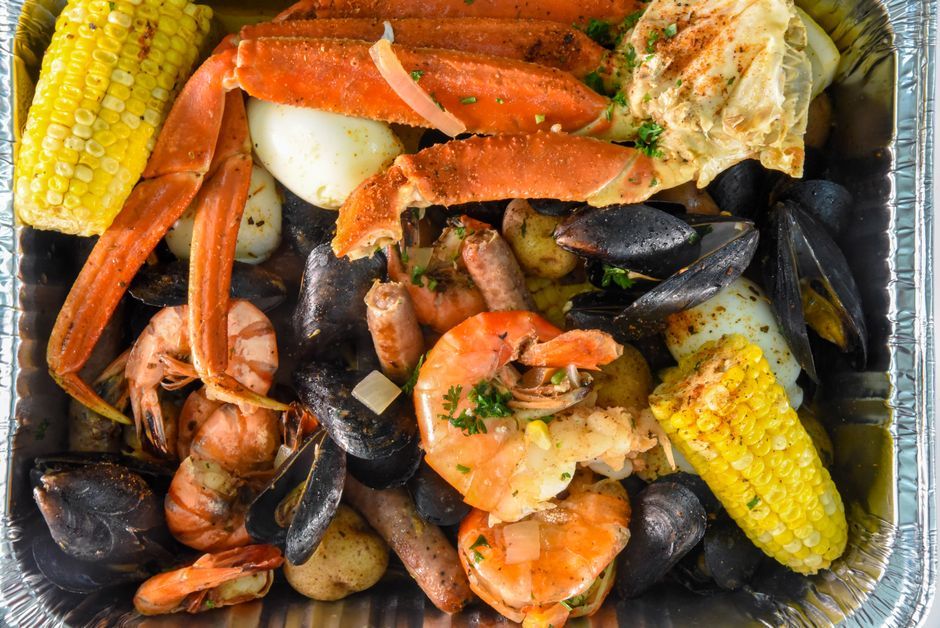 Seafood Boil — Shellfish boiled with corn and potato in seasoned broth.
