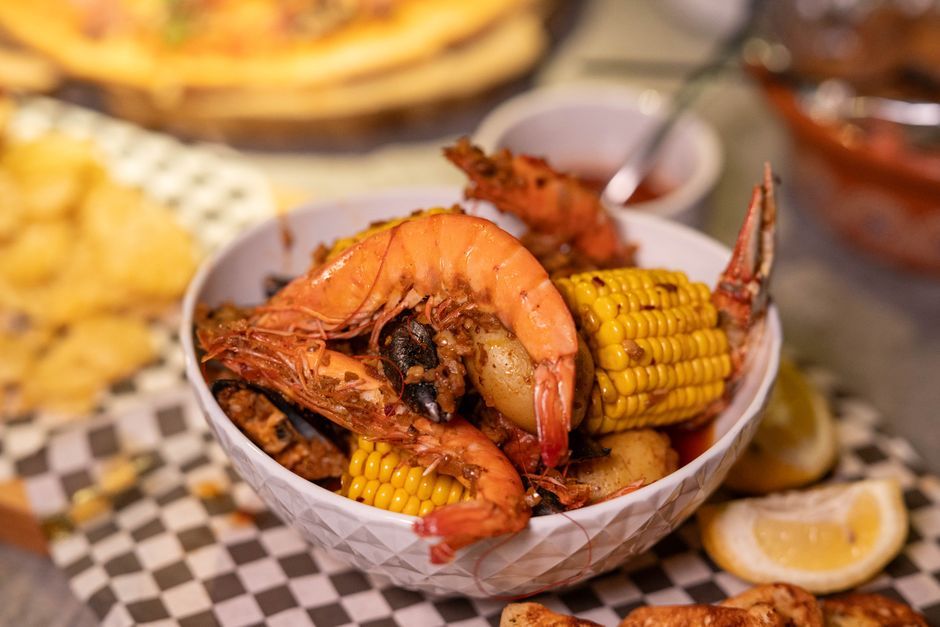 Seafood — Shellfish boiled with corn and potato in seasoned broth.